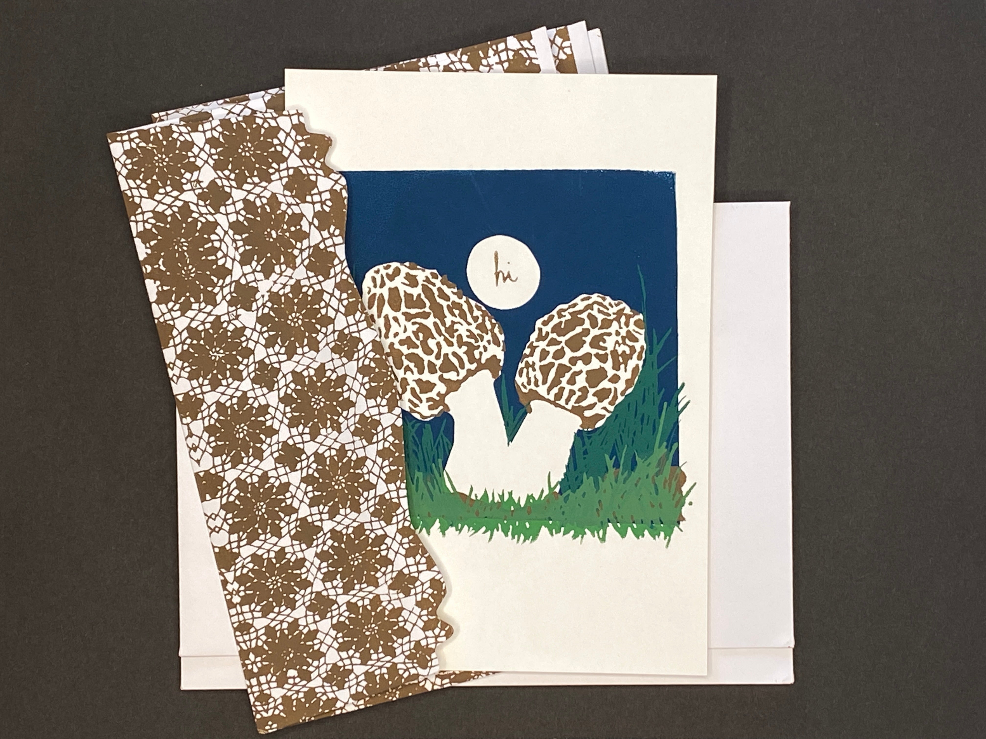 Greeting Card with two morel mushrooms with a 'hi' bubble on a blue background with coordinating hand printed envelopes