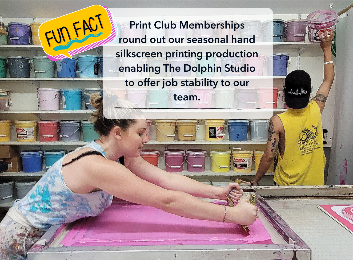 Lily and Johnny printing in front of ink bucket wall at the Dolphin Studio